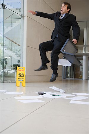 falling down in the office - Businessman slipping up Stock Photo - Premium Royalty-Free, Code: 614-02049836