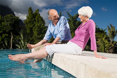 seniors women swimmingpool - A couple sat next to a pool Stock Photo - Premium Royalty-Free, Code: 614-02049958