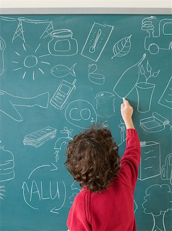 Boy writing on a blackboard Stock Photo - Premium Royalty-Free, Code: 614-02050297