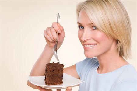 A woman holding a chocolate cake Stock Photo - Premium Royalty-Free, Code: 614-02050730