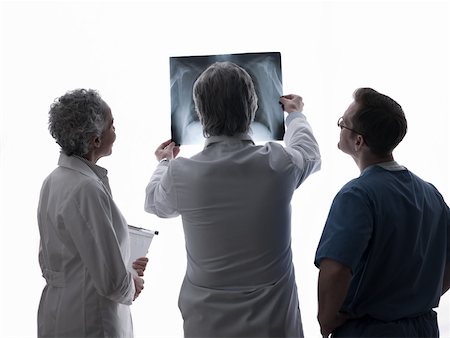 simsearch:614-02984110,k - Doctors and surgeon looking at x-ray Fotografie stock - Premium Royalty-Free, Codice: 614-02074424