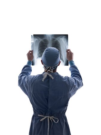 examen de pecho - Surgeon looking at x-ray Foto de stock - Sin royalties Premium, Código: 614-02074468