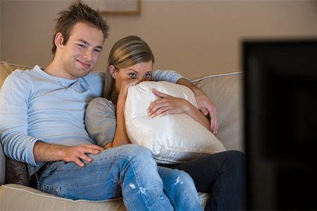 A young couple watching tv Stock Photo - Premium Royalty-Free, Code: 614-02074928