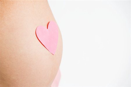 Heart on pregnant womans stomach Stock Photo - Premium Royalty-Free, Code: 614-02073136
