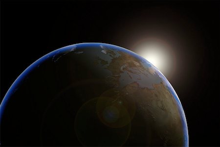 Sun emerging over planet earth Stock Photo - Premium Royalty-Free, Code: 614-02073662