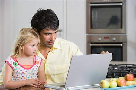 family kitchen laptop - A father and daughter looking at a laptop Stock Photo - Premium Royalty-Free, Code: 614-02073728