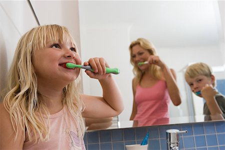A family brushing their teeth Stock Photo - Premium Royalty-Free, Code: 614-02073760