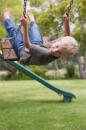 A boy on a swing Stock Photo - Premium Royalty-Free, Code: 614-02073798