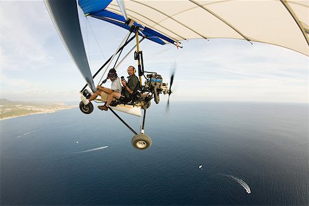 Pilot and photographer on ultralight aircraft Stock Photo - Premium Royalty-Free, Code: 614-02241080