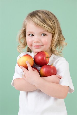 people with fruits cutout - Girl holding apples Stock Photo - Premium Royalty-Free, Code: 614-02241816