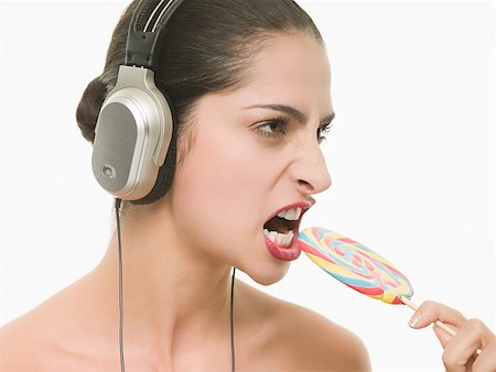 simsearch:614-02242038,k - Woman with heaphones and lollipop Stock Photo - Premium Royalty-Free, Code: 614-02242015