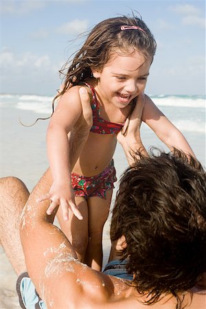 A father lifting his daughter Stock Photo - Premium Royalty-Free, Code: 614-02242118