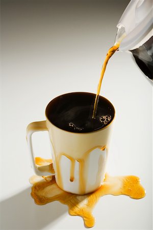 Coffee spilling out of a cup Stock Photo - Premium Royalty-Free, Code: 614-02242228