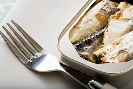 A can of sardines and a fork Stock Photo - Premium Royalty-Free, Code: 614-02242273