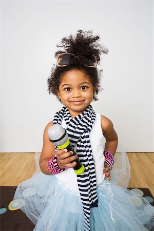 Portrait of a girl holding a microphone Stock Photo - Premium Royalty-Free, Code: 614-02242652