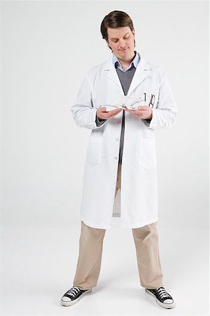 full body image of person in lab coat - Scientist holding rat Stock Photo - Premium Royalty-Free, Code: 614-02242884