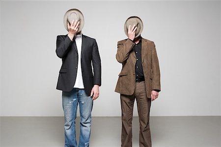 prop - Men holding hats over their faces Stock Photo - Premium Royalty-Free, Code: 614-02243018