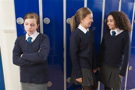 sulking arms folded - Girl excluded from group Stock Photo - Premium Royalty-Free, Code: 614-02243478