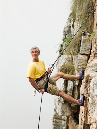 risk - Man abseiling Foto de stock - Sin royalties Premium, Código: 614-02258113