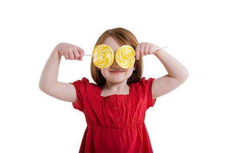 A girl covering her eyes with lollipops Stock Photo - Premium Royalty-Free, Code: 614-02258138