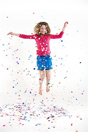 falling confetti with white background - Une jeune fille sautant Photographie de stock - Premium Libres de Droits, Code: 614-02258167