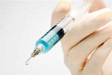 doctor syringe close up - A doctor holding a syringe Stock Photo - Premium Royalty-Free, Code: 614-02258535