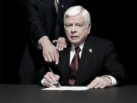 politician - Politician being made to sign Stock Photo - Premium Royalty-Free, Code: 614-02259053