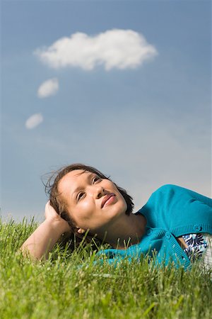 speech bubble with someone thinking - Woman lying on grass thinking Stock Photo - Premium Royalty-Free, Code: 614-02343059