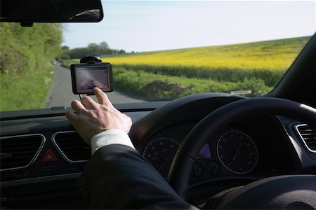 dashboard in car - A man pointing to a gps Stock Photo - Premium Royalty-Free, Code: 614-02343360