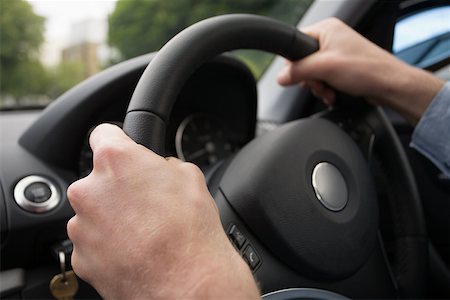 dashboard in car - Hands on a steering wheel Stock Photo - Premium Royalty-Free, Code: 614-02343406