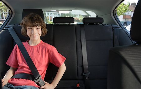 Portrait of a boy wearing a seatbelt Stock Photo - Premium Royalty-Free, Code: 614-02343413