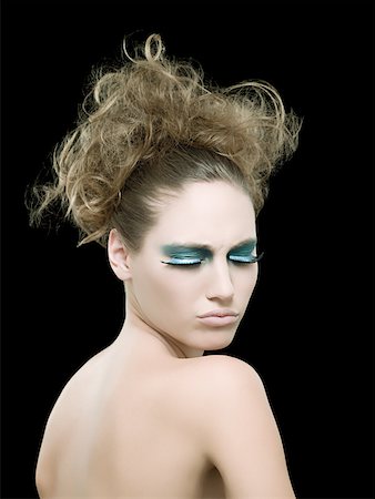 eye shadow - A young woman wearing false eyelashes Fotografie stock - Premium Royalty-Free, Codice: 614-02343552