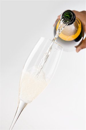 sparkling wine - A person pouring champagne into a flute Stock Photo - Premium Royalty-Free, Code: 614-02394216