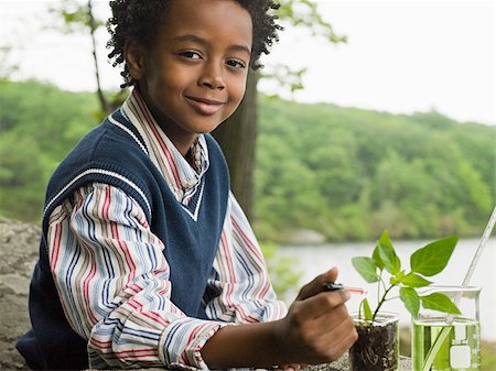 A boy doing an experiment on a plant Stock Photo - Premium Royalty-Free, Code: 614-02392209