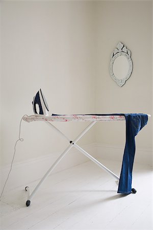 Iron on ironing board Stock Photo - Premium Royalty-Free, Code: 614-02392688