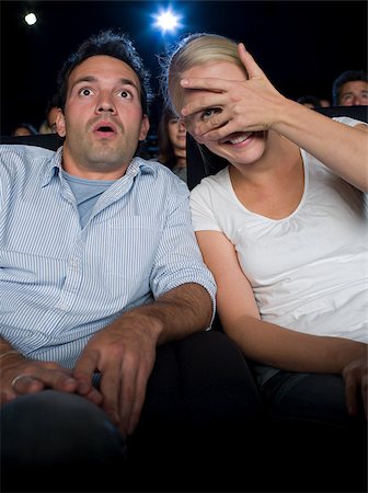 A couple watching a scary movie Stock Photo - Premium Royalty-Free, Code: 614-02393016