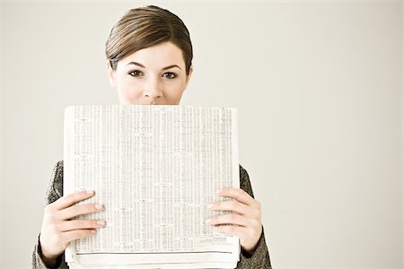 risk finance - Portrait of a woman holding a newspaper Stock Photo - Premium Royalty-Free, Code: 614-02393218