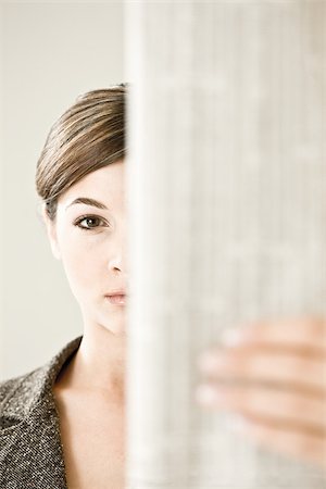 A woman reading the financial paper Stock Photo - Premium Royalty-Free, Code: 614-02393234