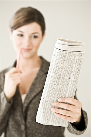 A woman reading the financial paper Stock Photo - Premium Royalty-Free, Code: 614-02393240