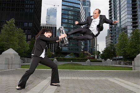 person leaping city - Businesspeople practising capoeira Stock Photo - Premium Royalty-Free, Code: 614-02393523