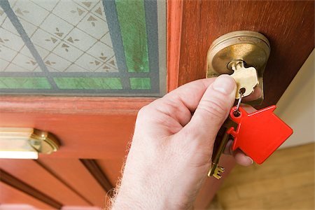 Person opening front door Stock Photo - Premium Royalty-Free, Code: 614-02393822