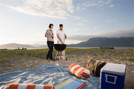 Couple having a barbecue on an island Stock Photo - Premium Royalty-Free, Code: 614-02611775