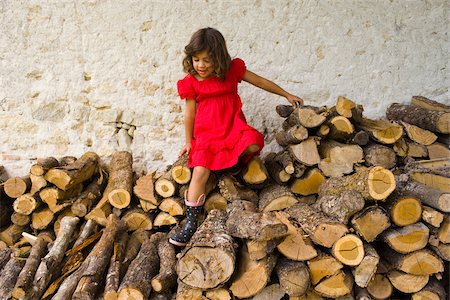 A girl climbing on logs Stock Photo - Premium Royalty-Free, Code: 614-02612097