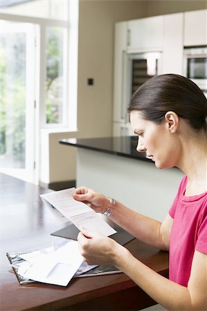 Woman reading letter Stock Photo - Premium Royalty-Free, Code: 614-02612680