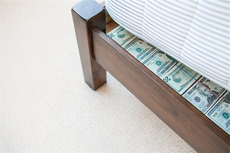 Money hidden under a mattress Stock Photo - Premium Royalty-Free, Code: 614-02612817