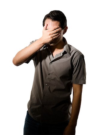 Young man covering his eyes Fotografie stock - Premium Royalty-Free, Codice: 614-02613840