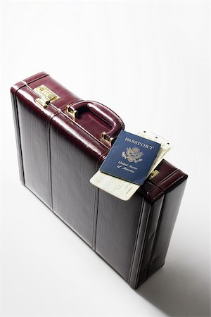 passport travel - Briefcase tickets and a passport Stock Photo - Premium Royalty-Free, Code: 614-02639695