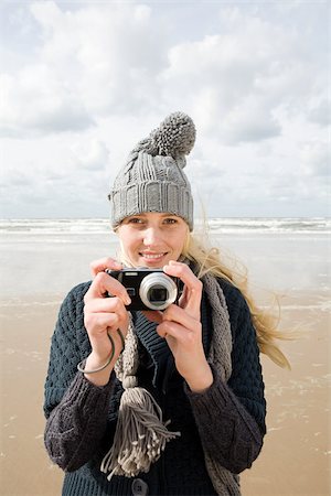 Woman by the sea with camera Stock Photo - Premium Royalty-Free, Code: 614-02639989