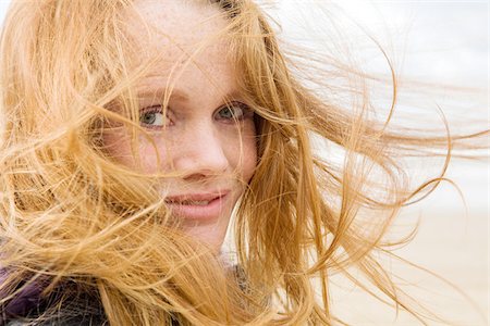 Woman with hair blowing in breeze Stock Photo - Premium Royalty-Free, Code: 614-02639990
