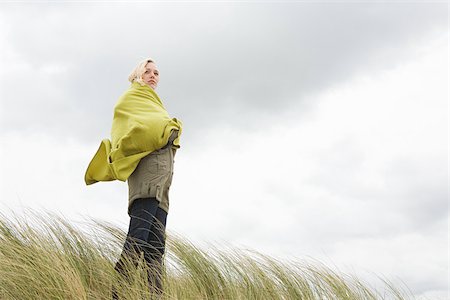 Woman at the coast in blanket Stock Photo - Premium Royalty-Free, Code: 614-02640005